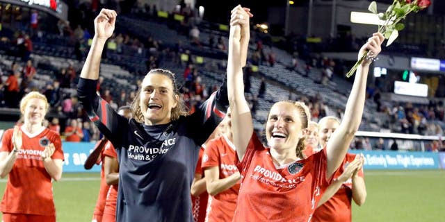 Portland Thorns goalkeeper Nadine Angerer, left, and defender Rachel Van Hollebeke celebrate after an NWSL soccer match against the Washington Spirit in Portland, Ore., Sunday, Aug. 30, 2015. Both players have announced their retirement from soccer. The teams tied 3-3. (AP Photo/Don Ryan)