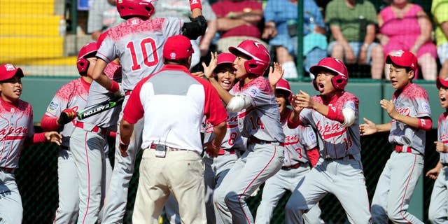 Aug 30, 2015; Williamsport, PA, USA; Japan Region outfielder Kengo Tomita (14) celebrates after hitting a home run in the second inning against the Mid-Atlantic Region at Howard J. Lamade Stadium. Mandatory Credit: Evan Habeeb-USA TODAY Sports
