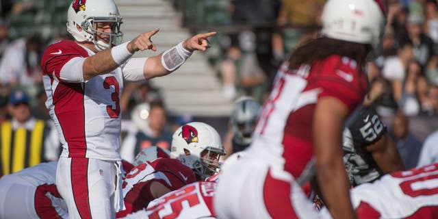 August 30, 2015; Oakland, CA, USA; Arizona Cardinals quarterback Carson Palmer (3) signals at the line of scrimmage against the Oakland Raiders during the first quarter in a preseason NFL football game at O.co Coliseum. Mandatory Credit: Kyle Terada-USA TODAY Sports