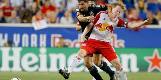 Aug 30, 2015; Harrison, NJ, USA; D.C. United midfielder/forward Chris Pontius (13) and New York Red Bulls midfielder Dax McCarty (11) battle for the ball during first half at Red Bull Arena. Mandatory Credit: Noah K. Murray-USA TODAY Sports