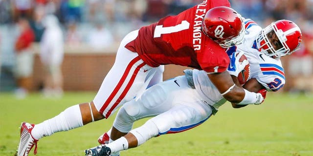 Aug 30, 2014; Norman, OK, USA; Oklahoma Sooners linebacker Dominique Alexander (1) tackles Louisiana Tech Bulldogs running back Kenneth Dixon (28) during the first half at Gaylord Family - Oklahoma Memorial Stadium. Mandatory Credit: Kevin Jairaj-USA TODAY Sports