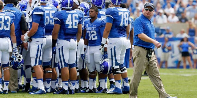 Aug 30, 2014; Lexington, KY, USA; Kentucky Wildcats head coach Mark Stoops during a time out in the game against the UT Martin Skyhawks in the second half at Commonwealth Stadium. Kentucky defeated UT Martin 59-14. Mandatory Credit: Mark Zerof-USA TODAY Sports