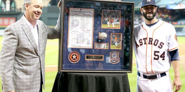 HOUSTON, TX - AUGUST 31: Mike Fiers #54 receives from Houston Astros owner Jim Crane a shadowbox of momentos from his no hitter on August 21, 2015 at Minute Maid Park on August 31, 2015 in Houston, Texas. (Photo by Bob Levey/Getty Images)