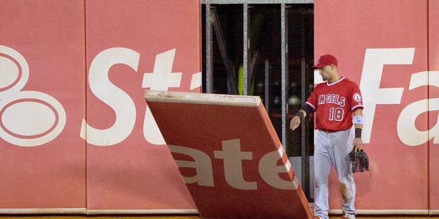 OAKLAND, CA - AUGUST 31: Shane Victorino #18 of the Los Angeles Angels of Anaheim watches as a piece of the outfield wall falls onto the field during the fifth inning against the Oakland Athletics at O.co Coliseum on August 31, 2015 in Oakland, California. (Photo by Jason O. Watson/Getty Images)