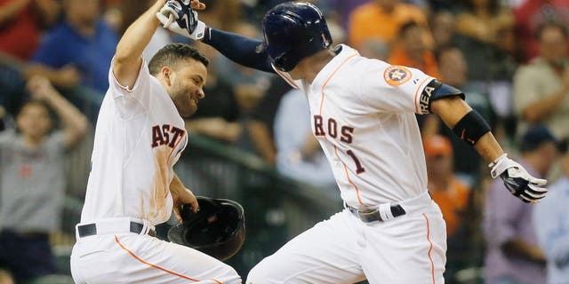 HOUSTON, TX - AUGUST 31: Carlos Correa #1 of the Houston Astros is congratulated by Jose Altuve #27 after hitting a home run in the fifth inning against the Seattle Mariners at Minute Maid Park on August 31, 2015 in Houston, Texas. (Photo by Bob Levey/Getty Images)