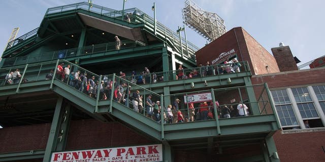 BOSTON - JUNE 7: Fans walk through Fenway Park in Boston, Mass., June 7, 2015. A little known, more than a century old so-called baseball rule, states that stadium owners and operators are not responsible for injuries sustained by foul balls or shards of bat so long as netted or screened seats are available to the vast majority of spectators. (Photo by Keith Bedford for The Boston Globe via Getty Images)