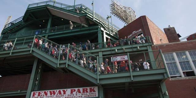BOSTON - JUNE 7: Fans walk through Fenway Park in Boston, Mass., June 7, 2015. A little known, more than a century old so-called baseball rule, states that stadium owners and operators are not responsible for injuries sustained by foul balls or shards of bat so long as netted or screened seats are available to the vast majority of spectators. (Photo by Keith Bedford for The Boston Globe via Getty Images)