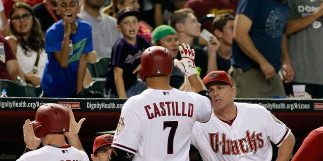 PHOENIX, AZ - AUGUST 28: Welington Castillo #7 of the Arizona Diamondbacks is congratulated by manager Chip Hale #3 (R) after hitting a sacrifice fly against the Oakland Athletics to score Paul Goldschmidt #44 (L) during the sixth inning of a MLB game at Chase Field on August 28, 2015 in Phoenix, Arizona. The Diamondbacks defeated the Athletics 6-4. (Photo by Ralph Freso/Getty Images)