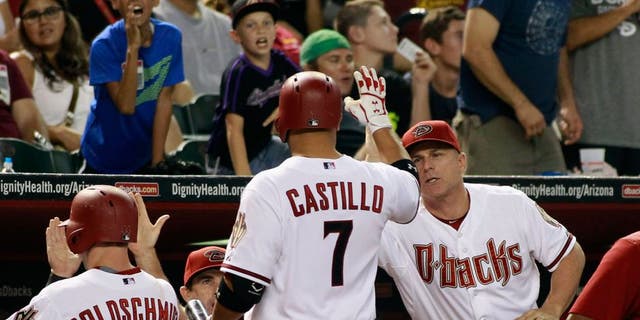 PHOENIX, AZ - AUGUST 28: Welington Castillo #7 of the Arizona Diamondbacks is congratulated by manager Chip Hale #3 (R) after hitting a sacrifice fly against the Oakland Athletics to score Paul Goldschmidt #44 (L) during the sixth inning of a MLB game at Chase Field on August 28, 2015 in Phoenix, Arizona. The Diamondbacks defeated the Athletics 6-4. (Photo by Ralph Freso/Getty Images)