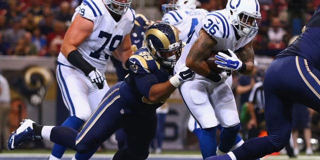ST. LOUIS, MO - AUGUST 29: Aaron Donald #99 of the St. Louis Rams tackles Daniel Herron #36 of the Indianapolis Colts in the second quarter during a preseason game at the Edward Jones Dome on August 29, 2014 in St. Louis, Missouri. (Photo by Dilip Vishwanat/Getty Images)