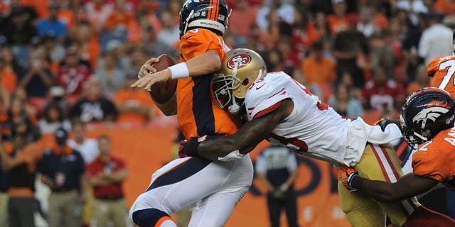 DENVER, CO - AUGUST 29: Denver Broncos quarterback Peyton Manning gets sacked by San Francisco 49ers linebacker NaVorro Bowman in the first quarter at Sports Authority Field at Mile High on Saturday, August 29, 2015. (Photo by Steve Nehf/The Denver Post via Getty Images)