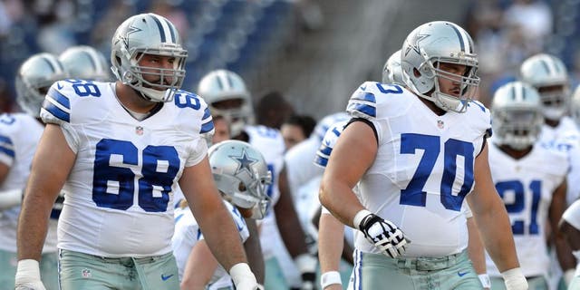 Aug 7, 2014; San Diego, CA, USA; Dallas Cowboys tackle Doug Free (68) and guard Zack Martin (70) warm-up before the game against the San Diego Chargers at Qualcomm Stadium. Mandatory Credit: Jake Roth-USA TODAY Sports