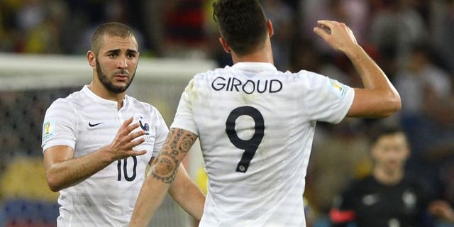 France's forward Olivier Giroud (R) and France's forward Karim Benzema shake hands after drawing 0-0 at the end of the Group E football match between Ecuador and France at the Maracana Stadium in Rio de Janeiro during the 2014 FIFA World Cup on June 25, 2014. AFP PHOTO / FRANCK FIFE (Photo credit should read FRANCK FIFE/AFP/Getty Images)