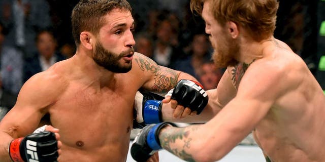 LAS VEGAS, NV - JULY 11: (L-R) Chad Mendes punches Conor McGregor in their UFC interim featherweight title fight during the UFC 189 event inside MGM Grand Garden Arena on July 11, 2015 in Las Vegas, Nevada. (Photo by Josh Hedges/Zuffa LLC/Zuffa LLC via Getty Images)