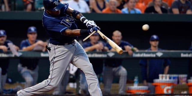 Aug 31, 2015; Baltimore, MD, USA; Tampa Bay Rays designated hitter Tim Beckham (1) hits a sacrifice fly scoring second baseman Logan Forsythe (not pictured) during the second inning against the Baltimore Orioles at Oriole Park at Camden Yards. Mandatory Credit: Tommy Gilligan-USA TODAY Sports
