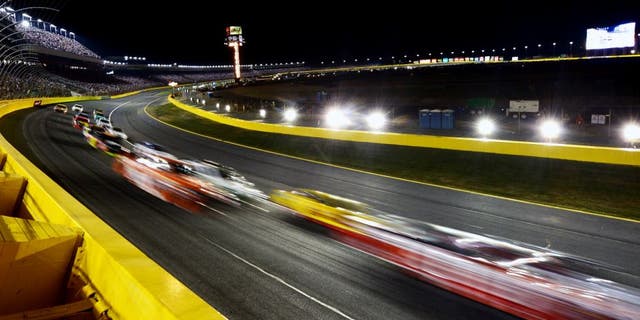 CHARLOTTE, NC - MAY 16: Cars race during the NASCAR Sprint Cup Series Sprint All-Star Race at Charlotte Motor Speedway on May 16, 2015 in Charlotte, North Carolina. (Photo by Drew Hallowell/Getty Images)