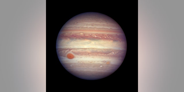 FILE - This April 3, 2017 file image made available by NASA shows the planet Jupiter when it was at a distance of about 668 million kilometers (415 million miles) from Earth. (NASA, ESA, and A. Simon (GSFC) via AP, File)