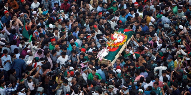 FILE - In this Feb. 16, 2013 file photo, Bangladeshi mourners carry the coffin containing the body of blogger Rajib Haider for funeral in Dhaka, Bangladesh. Haider had been critical of the Islamic group Jamaat-e-Islami, whose leader Abdul Quader Mollah was recently given a life sentence for his role in the killing of 381 civilians during the nation’s 1971 war for independence from Pakistan. On Sunday, Feb. 17, 2013, Bangladesh parliament has amended the country’s war crimes law that will allow the prosecution to appeal the life imprisonment of an opposition leader which it says has been lenient. (AP Photo/Pavel Rahman, File)