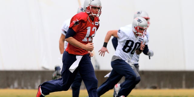 TEMPE, AZ - JANUARY 30: Tom Brady #12 of the New England Patriots warms up during the New England Patriots Super Bowl XLIX Practice on January 30, 2015 at the Arizona Cardinals Practice Facility in Tempe, Arizona. (Photo by Elsa/Getty Images)