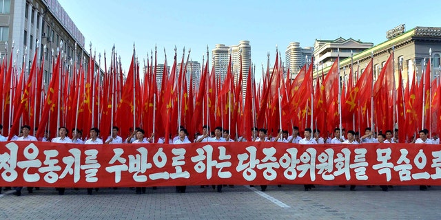People participate in a Pyongyang rally in support of North Korean leader Kim Jong Un.