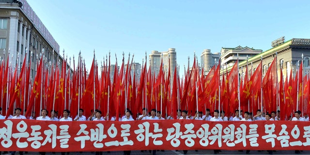 People participate in a Pyongyang rally in support of North Korean leader Kim Jong Un.