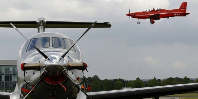 Pilatus DC-21 (R) comes into land over a Pilatus PC-12.