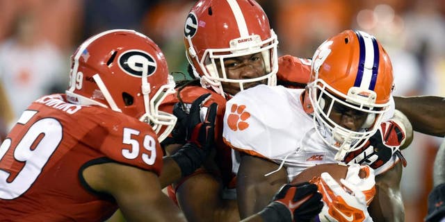 Aug 30, 2014; Athens, GA, USA; Clemson Tigers running back D.J. Howard (22) is tackled by Georgia Bulldogs linebacker Jordan Jenkins (59) and linebacker Ramik Wilson (51) during the second half at Sanford Stadium. Georgia defeated Clemson 45-21. Mandatory Credit: Dale Zanine-USA TODAY Sports