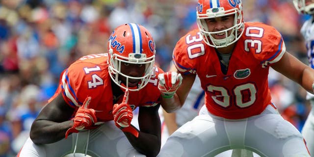 Apr 11, 2015; Gainesville, FL, USA;Florida Gators defensive lineman Alex McCalister (14) and tight end DeAndre Goolsby (30) react during the second half at the Orange and Blue Debut at Ben Hill Griffin Stadium. Orange defeated Blue 31-6. Mandatory Credit: Kim Klement-USA TODAY Sports