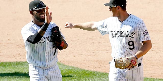 DENVER, CO - SEPTEMBER 01: Shortstop Jose Reyes #7 of the Colorado Rockies and second baseman DJ LeMahieu #9 of the Colorado Rockies celebrate after they teamed up with Ben Paulsen #10 of the Colorado Rockies for a triple play on a line drive by Paul Goldschmidt #44 of the Arizona Diamondbacks in the ninth inning at Coors Field on September 1, 2015 in Denver, Colorado. The Diamondbacks defeated the Rockies 6-4. (Photo by Doug Pensinger/Getty Images)