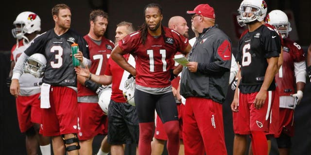 GLENDALE, AZ - AUGUST 02: (L-R) Carson Palmer #3, Larry Fitzgerald #11, Bruce Arians and Logan Thomas #6 of the Arizona Cardinals stand on the field during the team training camp at University of Phoenix Stadium on August 2, 2015 in Glendale, Arizona. (Photo by Christian Petersen/Getty Images)
