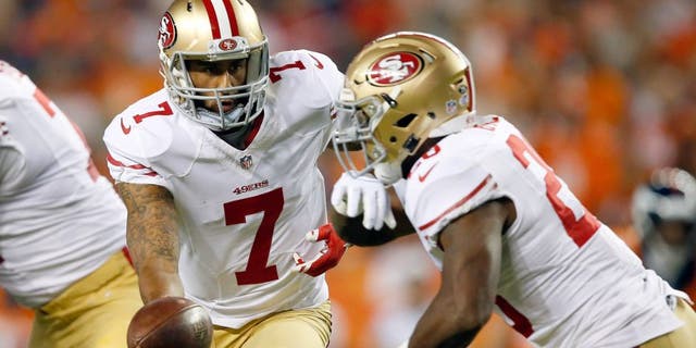DENVER, CO - AUGUST 29: Quarterback Colin Kaepernick #7 of the San Francisco 49ers hands the ball off to running back Carlos Hyde #28 of the San Francisco 49ers against the Denver Broncos during preseason action at Sports Authority Field at Mile High on August 29, 2015 in Denver, Colorado. (Photo by Doug Pensinger/Getty Images)