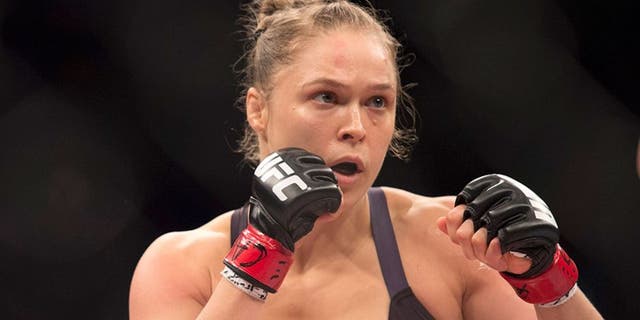 RIO DE JANEIRO, BRAZIL - AUGUST 01: UFC women's bantamweight champion Ronda Rousey of the United States rushes forward against Bethe Correia of Brazil during the UFC 190 event inside HSBC Arena on August 1, 2015 in Rio de Janeiro, Brazil. (Photo by Jeff Bottari/Zuffa LLC/Zuffa LLC via Getty Images)