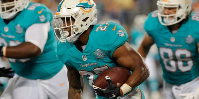 Aug 22, 2015; Charlotte, NC, USA; Miami Dolphins running back LaMichael James (27) returns a punt during the first half of the game against the Carolina Panthers at Bank of America Stadium. Mandatory Credit: Sam Sharpe-USA TODAY Sports