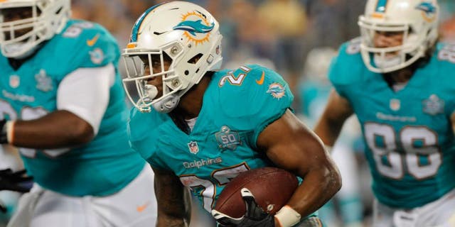 Aug 22, 2015; Charlotte, NC, USA; Miami Dolphins running back LaMichael James (27) returns a punt during the first half of the game against the Carolina Panthers at Bank of America Stadium. Mandatory Credit: Sam Sharpe-USA TODAY Sports