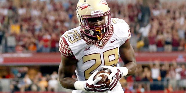 Aug 30, 2014; Arlington, TX, USA; Florida State Seminoles defensive back Nate Andrews (29) makes a touchdown run against the Oklahoma State Cowboys during the first quarter at AT&T Stadium. Mandatory Credit: Matthew Emmons-USA TODAY Sports