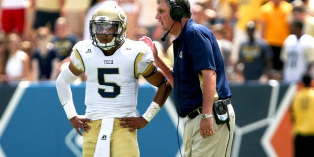 Aug 30, 2014; Atlanta, GA, USA; Georgia Tech Yellow Jackets head coach Paul Johnson talks with quarterback Justin Thomas (5) during the second quarter at Bobby Dodd Stadium. Georgia Tech won 38-19. Mandatory Credit: Kevin Liles-USA TODAY Sports