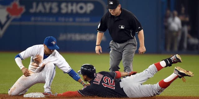 Sep 1, 2015; Toronto, Ontario, CAN; Cleveland Indians shortstop Francisco Lindor (12) slides safely into second with a double ahead of a tag from Toronto Blue Jays second baseman Ryan Goins (17) in the ninth inning at Rogers Centre.The Jays won 5-3. Mandatory Credit: Dan Hamilton-USA TODAY Sports