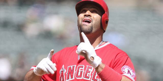 Sep 2, 2015; Oakland, CA, USA; Los Angeles Angels designated hitter Albert Pujols (5) celebrates after hitting a two run home run against the Oakland Athletics during the second inning at O.co Coliseum. Mandatory Credit: Kelley L Cox-USA TODAY Sports