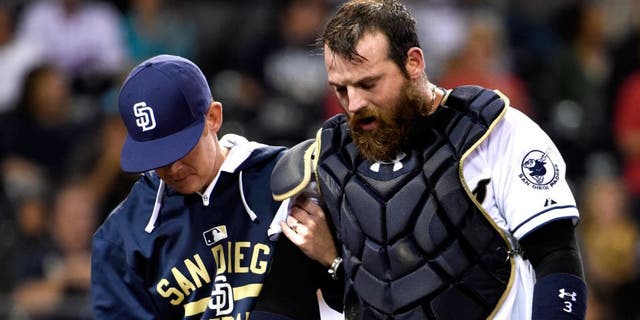 SAN DIEGO, CA - SEPTEMBER 1: Derek Norris #3 of the San Diego Padres, right, comes out of the game with a trainer during the seventh inning of a baseball game against the Texas Rangers at Petco Park September, 1, 2015 in San Diego, California. (Photo by Denis Poroy/Getty Images)