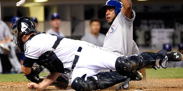 SAN DIEGO, CA - SEPTEMBER 1: Elvis Andrus #1 of the Texas Rangers steals home ahead of the tag of Austin Hedges #18 of the San Diego Padres during the seventh inning of a baseball game at Petco Park September, 1, 2015 in San Diego, California. (Photo by Denis Poroy/Getty Images)