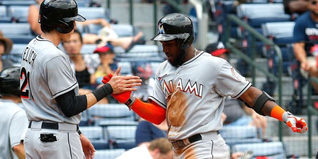 ATLANTA, GA - SEPTEMBER 02: Marcell Ozuna #13 of the Miami Marlins celebrates with Christian Yelich #21 after hitting a two-run homer in the fifth inning against the Atlanta Braves at Turner Field on September 2, 2015 in Atlanta, Georgia. (Photo by Kevin C. Cox/Getty Images)