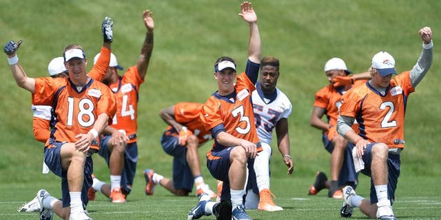 June 9, 2015; Englewood, CO, USA; Denver Broncos quarterback Peyton Manning (18) and quarterback Trevor Siemian (3) and quarterback Zac Dysert (2) warm up before the start of mini camp activities at the Broncos training facility. Mandatory Credit: Ron Chenoy-USA TODAY Sports