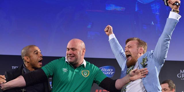 DUBLIN, IRELAND - MARCH 31: UFC featherweight title challenger Conor 'The Notorious' McGregor (R) steals UFC Featherweight Champion Jose Aldo's (L) belt as UFC President Dana White (C) separates the two during the UFC 189 World Championship Fan Event on March 31, 2015 in Dublin, Ireland. (Photo by Jeff Bottari/Zuffa LLC/Zuffa LLC via Getty Images)