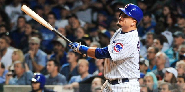 CHICAGO, IL - SEPTEMBER 01: Kyle Schwarber #12 of the Chicago Cubs hits a two-run home run against the Cincinnati Reds during the seventh inning on September 1, 2015 at Wrigley Field in Chicago, Illinois. (Photo by David Banks/Getty Images)