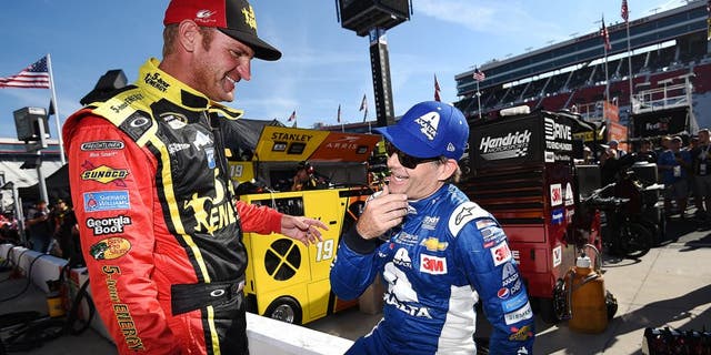 BRISTOL, TN - AUGUST 21: Clint Bowyer, driver of the #15 5-hour Energy Toyota, talks to Jeff Gordon, driver of the #24 Axalta Chevrolet, on the grid during qualifying for the NASCAR Sprint Cup Series Irwin Tools Night Race at Bristol Motor Speedway on August 21, 2015 in Bristol, Tennessee. (Photo by Rainier Ehrhardt/NASCAR via Getty Images)
