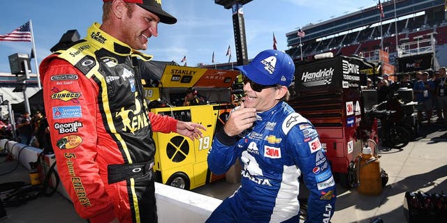 BRISTOL, TN - AUGUST 21: Clint Bowyer, driver of the #15 5-hour Energy Toyota, talks to Jeff Gordon, driver of the #24 Axalta Chevrolet, on the grid during qualifying for the NASCAR Sprint Cup Series Irwin Tools Night Race at Bristol Motor Speedway on August 21, 2015 in Bristol, Tennessee. (Photo by Rainier Ehrhardt/NASCAR via Getty Images)