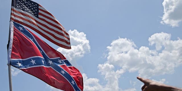 DAYTONA BEACH, FL - JULY 03: An American and a Confederate flag are seen during practice for the NASCAR Sprint Cup Series Coke Zero 400 at Daytona International Speedway on July 3, 2015 in Daytona Beach, Florida. (Photo by Patrick Smith/Getty Images)