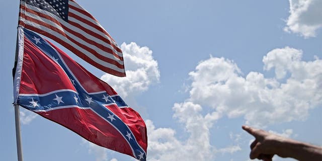 DAYTONA BEACH, FL - JULY 03: An American and a Confederate flag are seen during practice for the NASCAR Sprint Cup Series Coke Zero 400 at Daytona International Speedway on July 3, 2015 in Daytona Beach, Florida. (Photo by Patrick Smith/Getty Images)