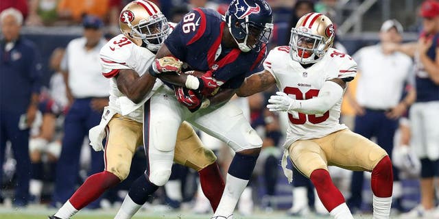 Aug 15, 2015; Houston, TX, USA; Houston Texans tight end Khari Lee (86) runs after a reception against San Francisco 49ers safety L.J. McCray (31) and cornerback Leon McFadden (30) in a preseason NFL football game at NRG Stadium. The Texans beat the 49ers 23-10. Mandatory Credit: Matthew Emmons-USA TODAY Sports