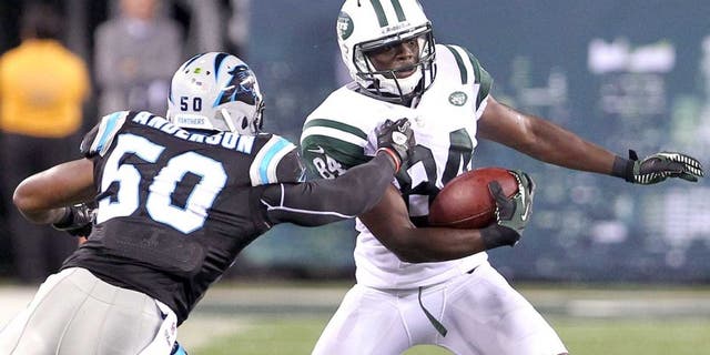 Aug 26, 2012; East Rutherford, NJ, USA; New York Jets wide receiver Stephen Hill (84) tries to avoid Carolina Panthers linebacker James Anderson (50) during the second half at MetLife Stadium. The Panthers defeated the Jets 17-12. Mandatory Credit: Ed Mulholland-USA TODAY Sports